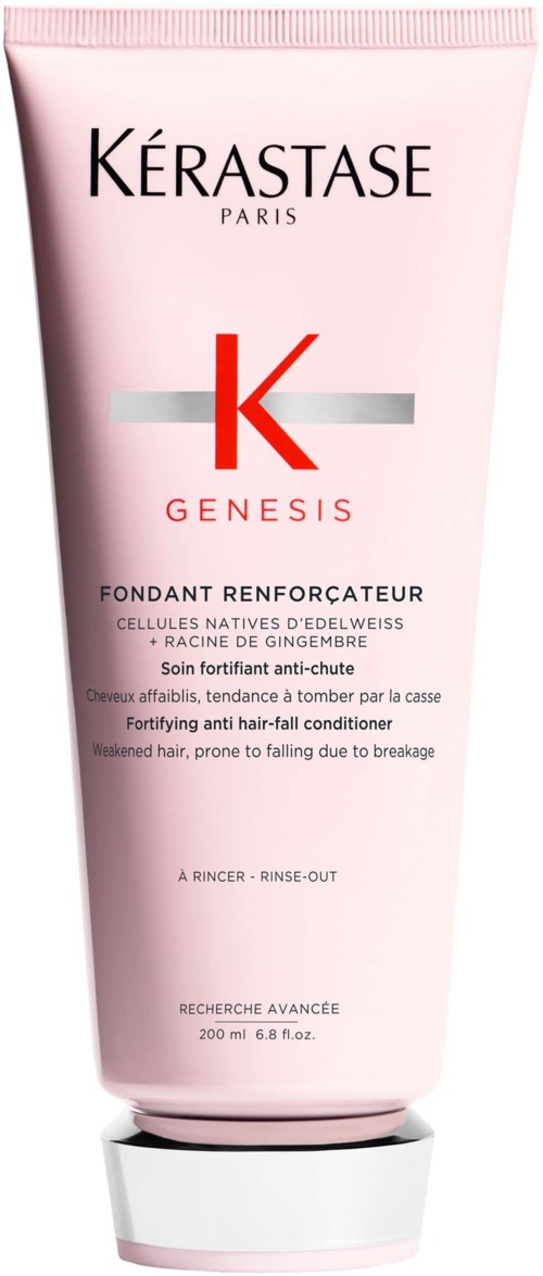 A pink tube of Kerastase Genesis fortifying hair conditioner with black, red, and gray text and a white cap.