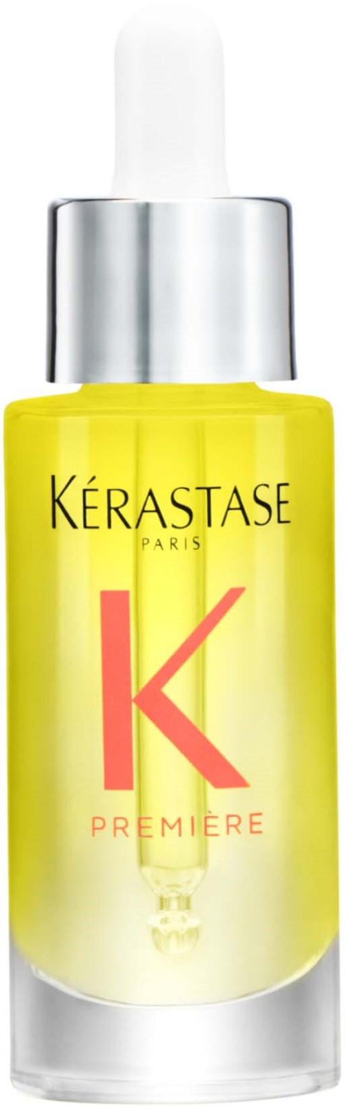 A small yellow bottle with a dropper, labeled 'Kérastase Paris K Premiere' for hair care products.