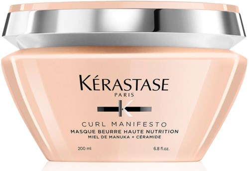 A pink jar of hair mask with a silver lid, labeled Kérastase Curl Manifesto, for high nutrition and moisture.