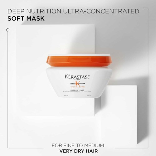 Een witte pot met oranje deksel, met het label Kerastase, met tekst over haarmaskers.