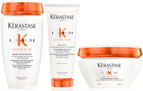 Drie haarverzorgingsproducten van Kérastase Nutritive: shampoo, conditioner en masker. Witte flessen met oranje doppen en labels.
