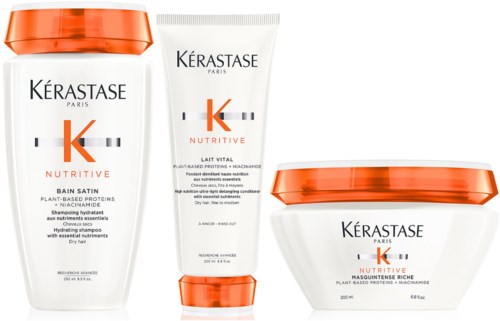 Drie haarverzorgingsproducten van Kérastase, inclusief shampoos en een masker, met oranje en witte verpakking.