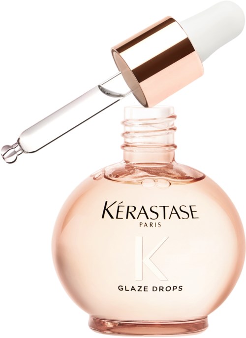 A skincare dropper is placed above a round pink bottle labeled 'Kérastase Paris Glaze Drops.'
