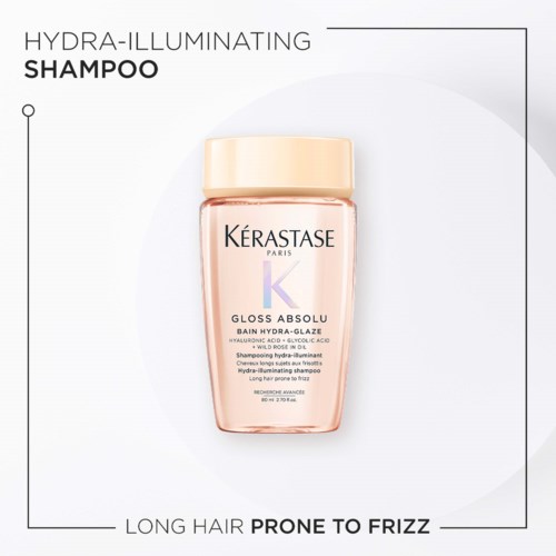 A shampoo bottle labeled Hydra-Illuminating, for long hair prone to frizz, with a beige cap and pinkish body.
