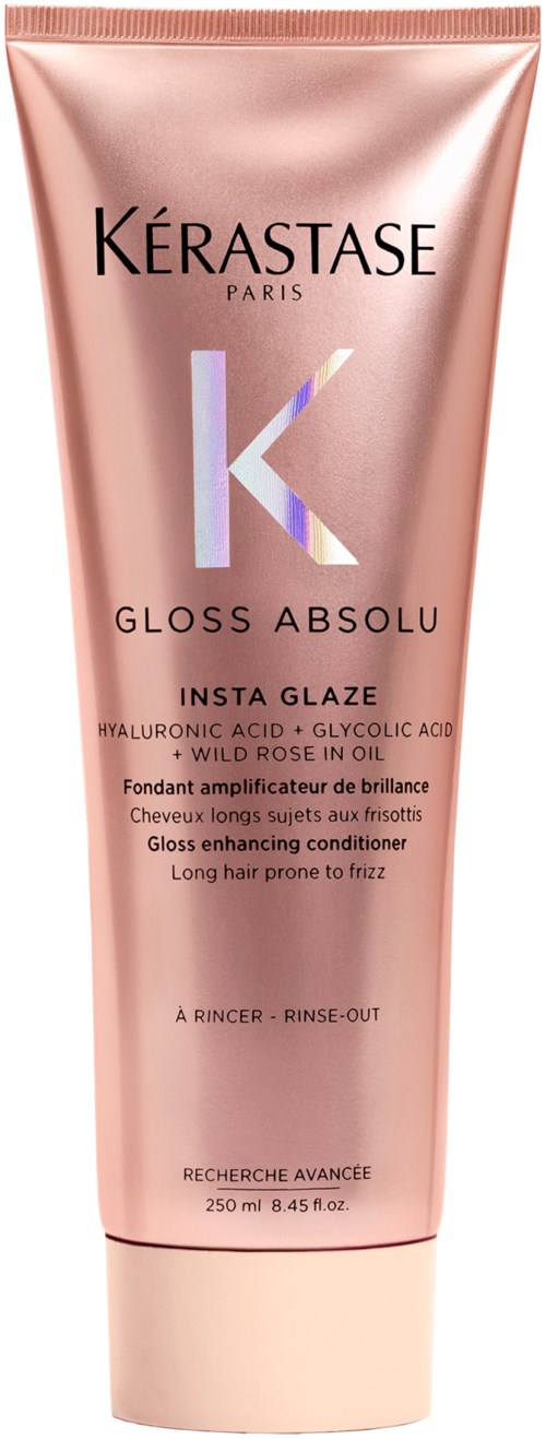 A pink tube of Kérastase Gloss Absolu hair conditioner with product details written on it.