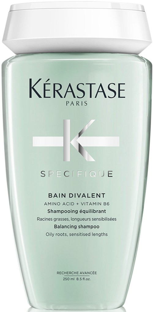 Eine grüne Flasche mit Kerastase-Shampoo, weißer Deckel, für fettiges Haar und empfindliche Längen.