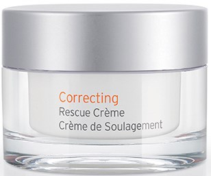 Ett tydligt glasburk med ett silverlock, märkt 'Correcting Rescue Creme' i orange och grå text.