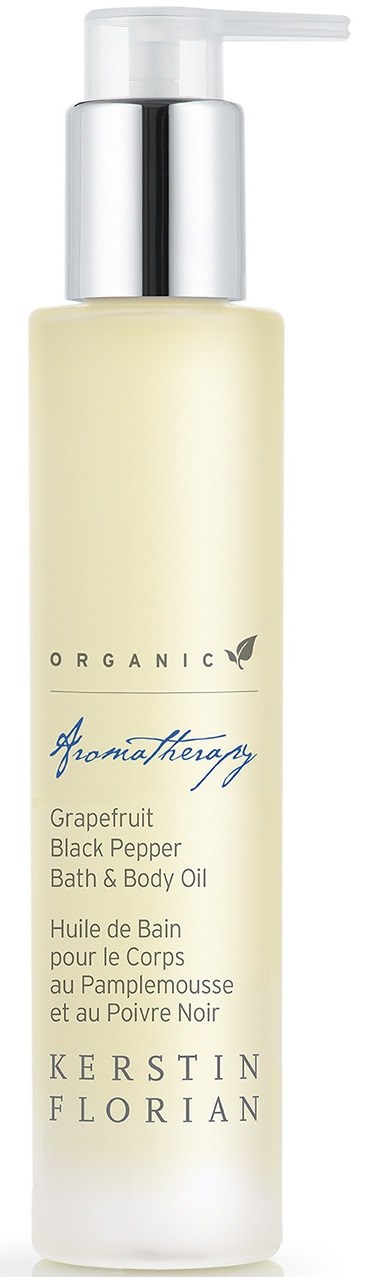 A tall, white bottle with a pump top labeled 'Grapefruit Black Pepper Bath & Body Oil' by Kerstin Florian.