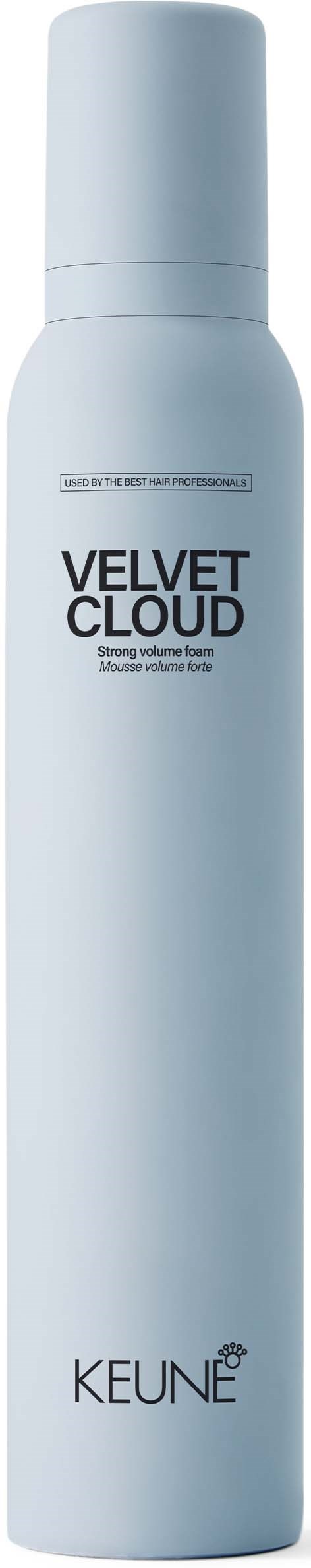 A tall, white spray bottle labeled 'Velvet Cloud' and 'Keune' stands upright, likely a hair or skincare product.