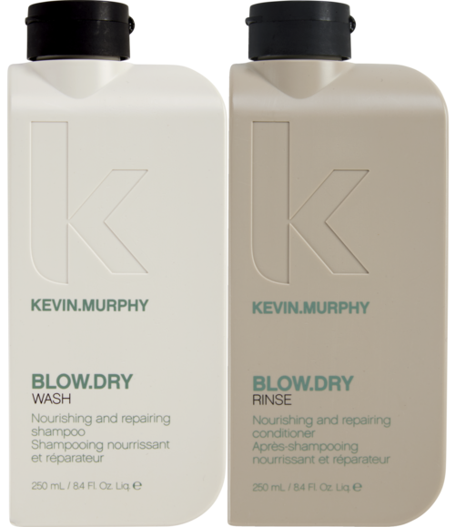 Two white bottles of hair care products, one for washing and one for rinsing, labeled with the brand Kevin.Murphy.