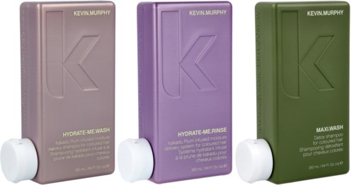 Three bottles in pastel colors: purple, beige, and green, labeled for hair wash, rinse, and max wash.