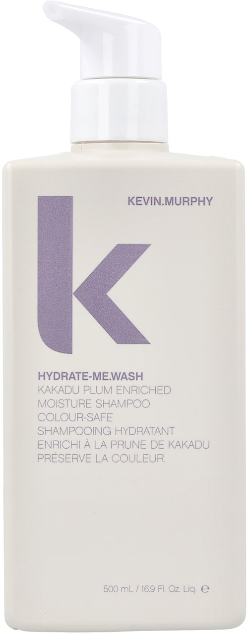 En vit flaska med pump innehåller Kevin Murphy hårschampo, märkt som hydrate-me wash med lila text och logo.
