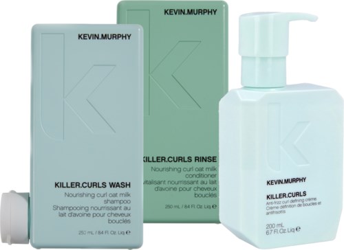 Two boxes of Kevin Murphy hair products and a white pump bottle. They are for hair care and moisturizing curls.
