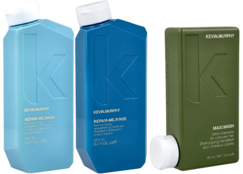 Three bottles of hair shampoo and conditioner from Kevin Murphy in blue and green bottles.
