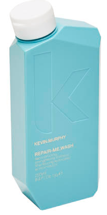 A blue bottle with a white cap, labeled Kevin Murphy Repair-Me-Wash. It looks like a shampoo bottle.