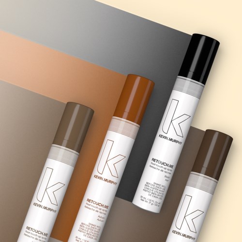 Fyra sprayfärgsburkar i olika färger: silver, brunt, svart och beige, placerade liggande.