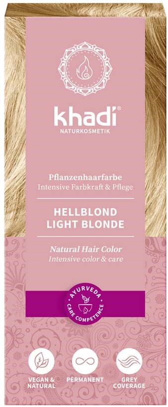 En rosa eske med tekst om hårfargning, lys blond nyanse, naturlig omsorg, etiske symboler og en logo øverst.
