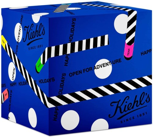Blå låda med svart, vitt, rosa och grönt streckta sugrör. Texten säger "Kiehl's," "sedan 1851," och "öppen för äventyr."