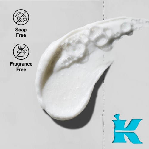 A droplet of creamy, white substance on a gray background with icons indicating soap and fragrance free.