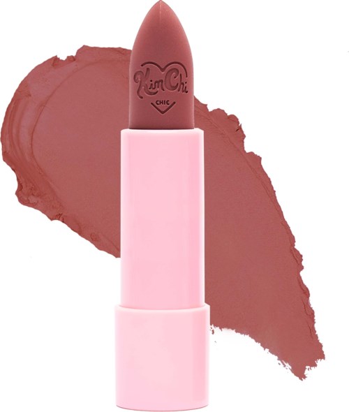 Pink lipstick with a heart-shaped logo, placed on a pink case with a lipstick smear background.