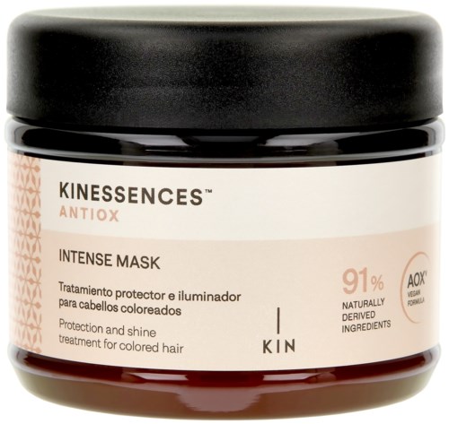 A hair mask jar with a white and black label, stating it provides protection and shine for colored hair.