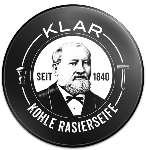 A circular logo with a man in the center, surrounded by German text and shaving-related symbols.