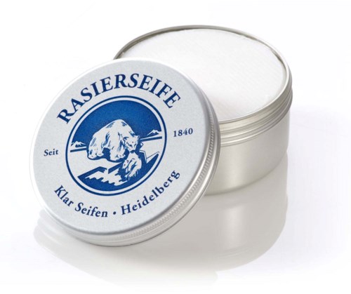 A small silver container with a white lid, labeled 'RASIERSEIFE,' showing a dog image and German text.