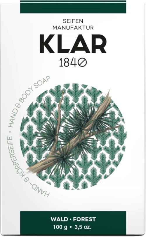 A soap packaging with green pine tree design, brand name KLAR, and mentions of forest scent and handmade soap.