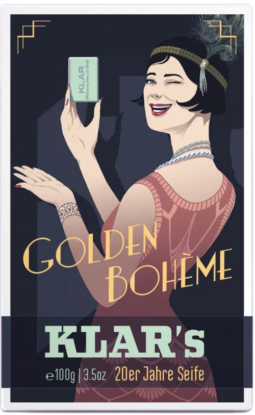 A woman with 1920s style hair and jewelry holds a soap bar, smiling. The label reads 'Klar' and 'Golden Boheme'.