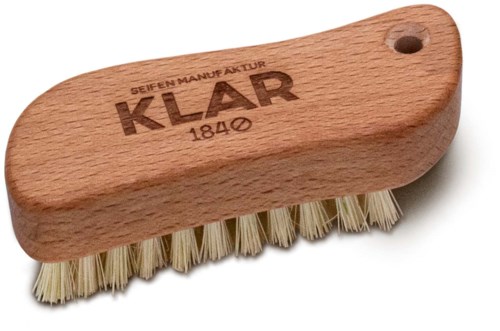 A wooden scrub brush with a hole on one end and bristles underneath. The brush has the brand name 'KLAR' engraved.