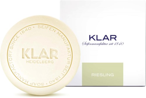 A soap bar with 'KLAR' written on it, next to a white box labeled 'KLAR Riesling'.