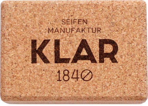 A soap bar with text in German, showing 'Klar 1840' and other details, on a beige background.