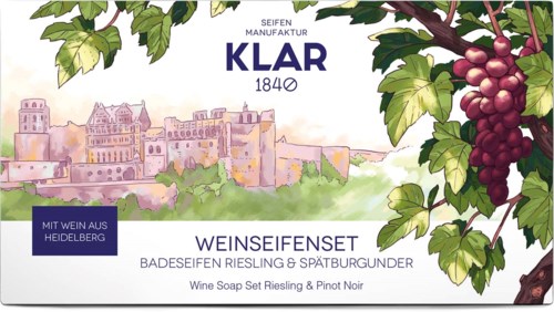 Label with grapes, cityscape, and text about wine soap set, Riesling, Pinot Noir, and Heidelberg.