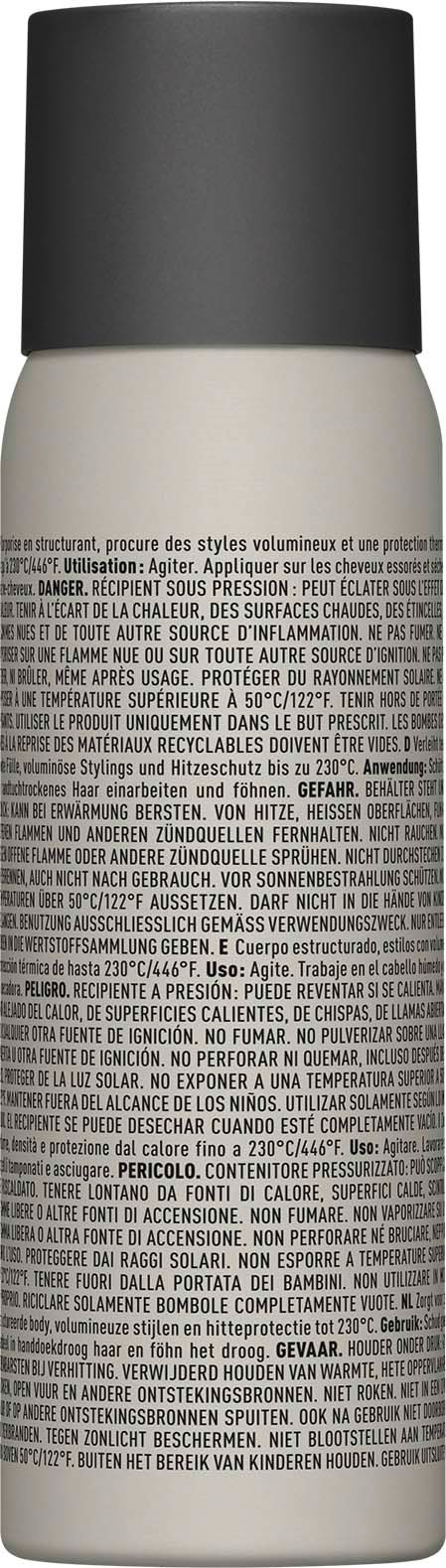 A white spray bottle with a black cap and many small printed instructions or text on the body.