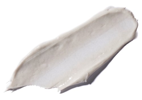 Ein Klecks weiße Creme oder Lotion auf weißem Hintergrund, glatte Textur.
