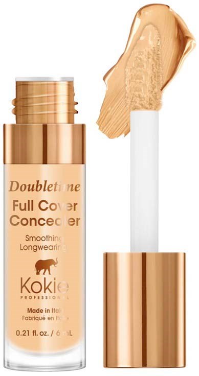 En beigefärgad flytande foundation med en vit applikatorstav, i en flaska med guldkork. Produkten heter 'Doubletone Full Cover Concealer'.