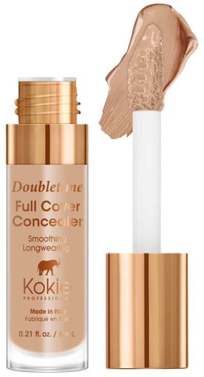 En beige concealerflaska med applikator och en klick concealer ovanpå.
