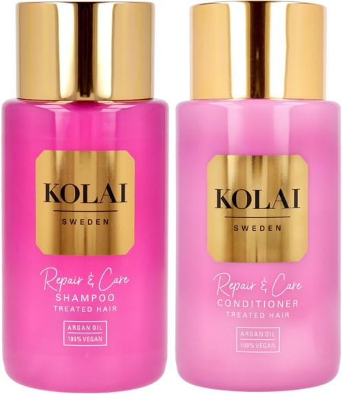 Two pink bottles with gold caps, labeled for shampoo and conditioner, meant for hair care. Both contain vegan, argan oil products.
