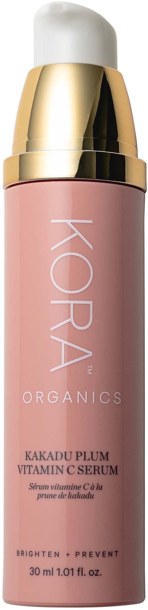 Eine rosa Flasche mit KORA Organics Vitamin-C-Serum mit weißem und goldenem Deckel.