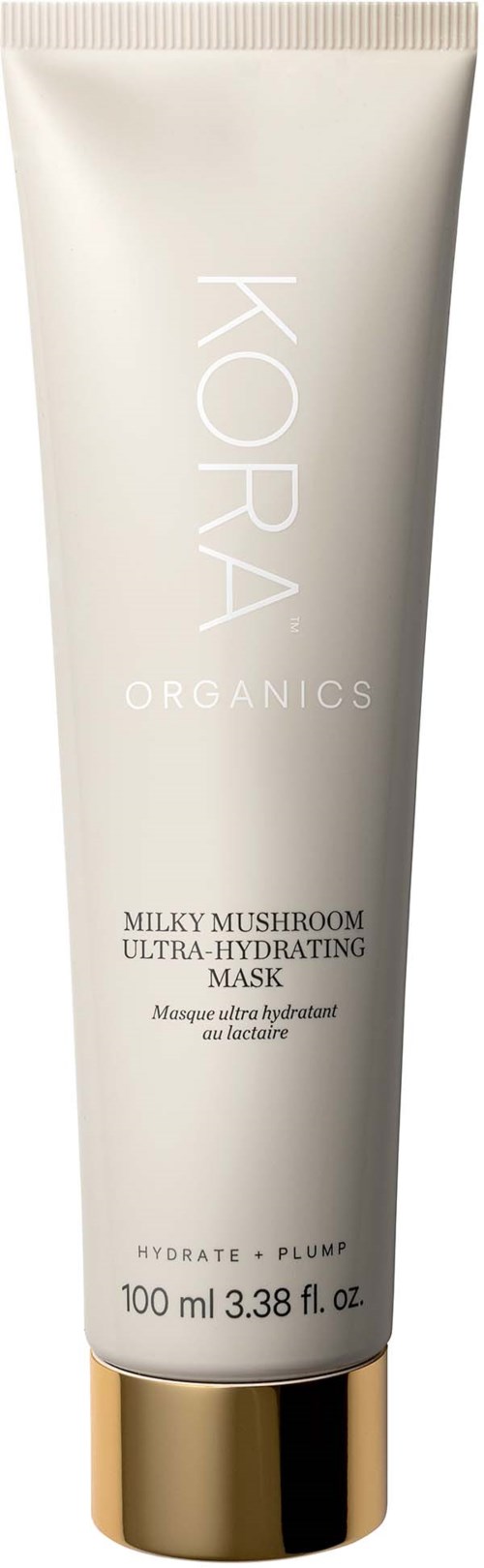 Eine weiße Tube mit 'KORA ORGANICS' und goldener Kappe, enthält eine Maske gegen Austrocknung und Fülle.
