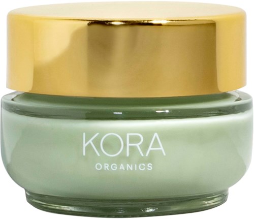 Ein kleiner Tiegel mit Kora Organics Creme, goldene Deckel und hellgrüner Körper.