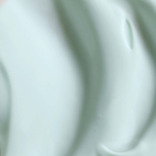 Eine glatte, hellgrüne Oberfläche mit weichen Kurven und glänzender, reflektierender Erscheinung.
