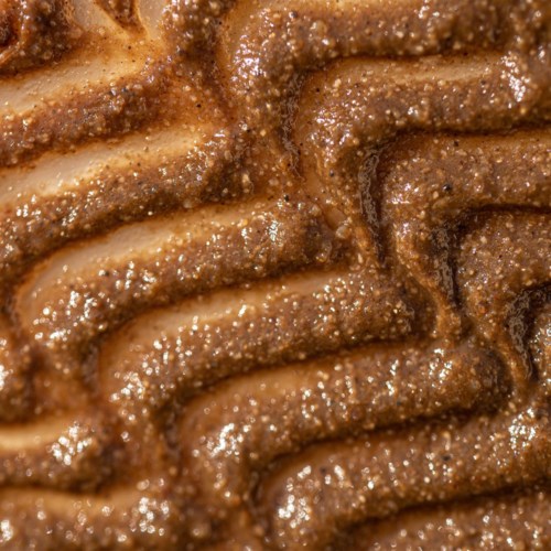 Close-up van chocolade- of kaneelgeparfumeerde churros met golven, knapperig en met suiker.