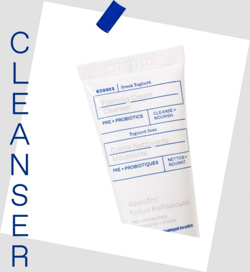 A small tube of Greek yogurt foam cleanser with blue text and blue accents on a white background.