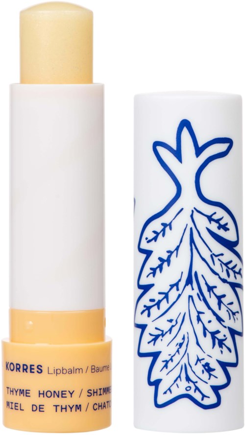 Lip balm with a white tube, yellow cap, and a blue leaf design on the cover.