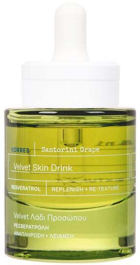 A small bottle with yellow liquid, a dropper top, and a label with text about skin care and grape fruit.