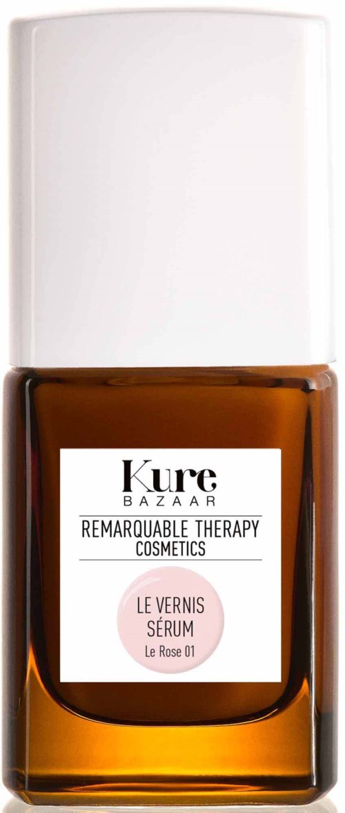 Braune Flasche mit Kure BAZAAR Nagellack, weißer Deckel, Etikett "Remarkable Therapy Cosmetics, Le Vernis Serum."