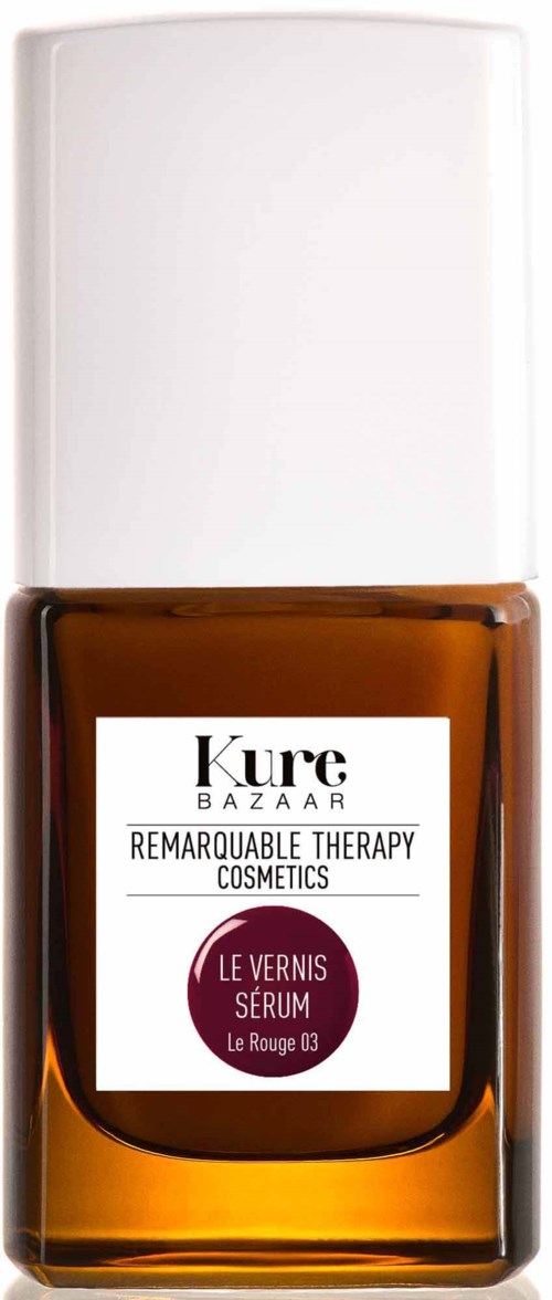 Eine kleine braune Flasche mit weißem Deckel und weißem Etikett, enthält Nagelserum von Kure Bazaar.