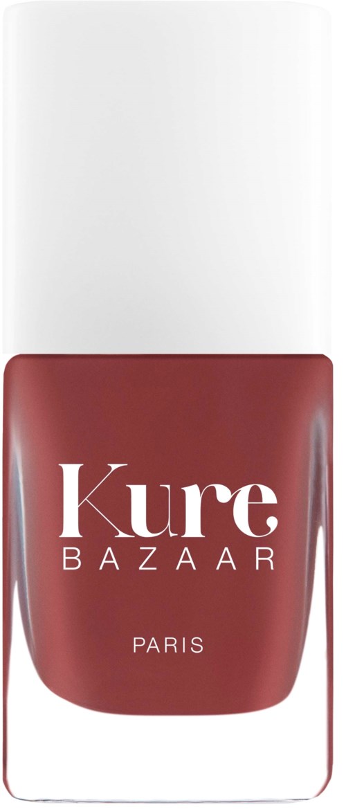 Ein Nagellackflasche mit weißem Deckel und rotem Etikett, auf dem steht "Kure BAZAAR PARIS."