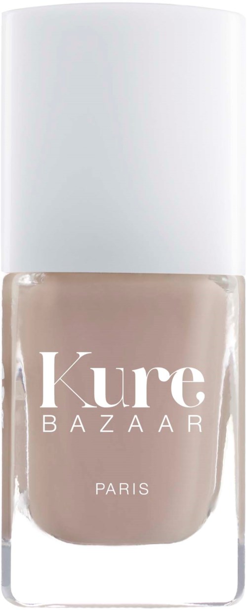 Ein beiger Nagellackflasche mit weißem Deckel, beschriftet 'Kure BAZAAR PARIS'.